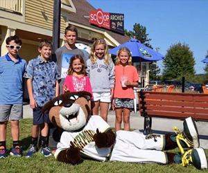 kids posing with the UVM catamount mascot